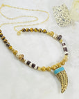 Handmade necklace with Tibetan brass horn and turquoise by Sarah Belle