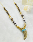 Handmade necklace with Tibetan brass horn and turquoise by Sarah Belle