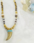 Handmade necklace with Tibetan brass horn and turquoise by Sarah Belle