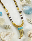 Handmade necklace with Tibetan brass horn and turquoise by Sarah Belle