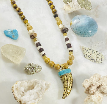 Handmade necklace with Tibetan brass horn and turquoise by Sarah Belle