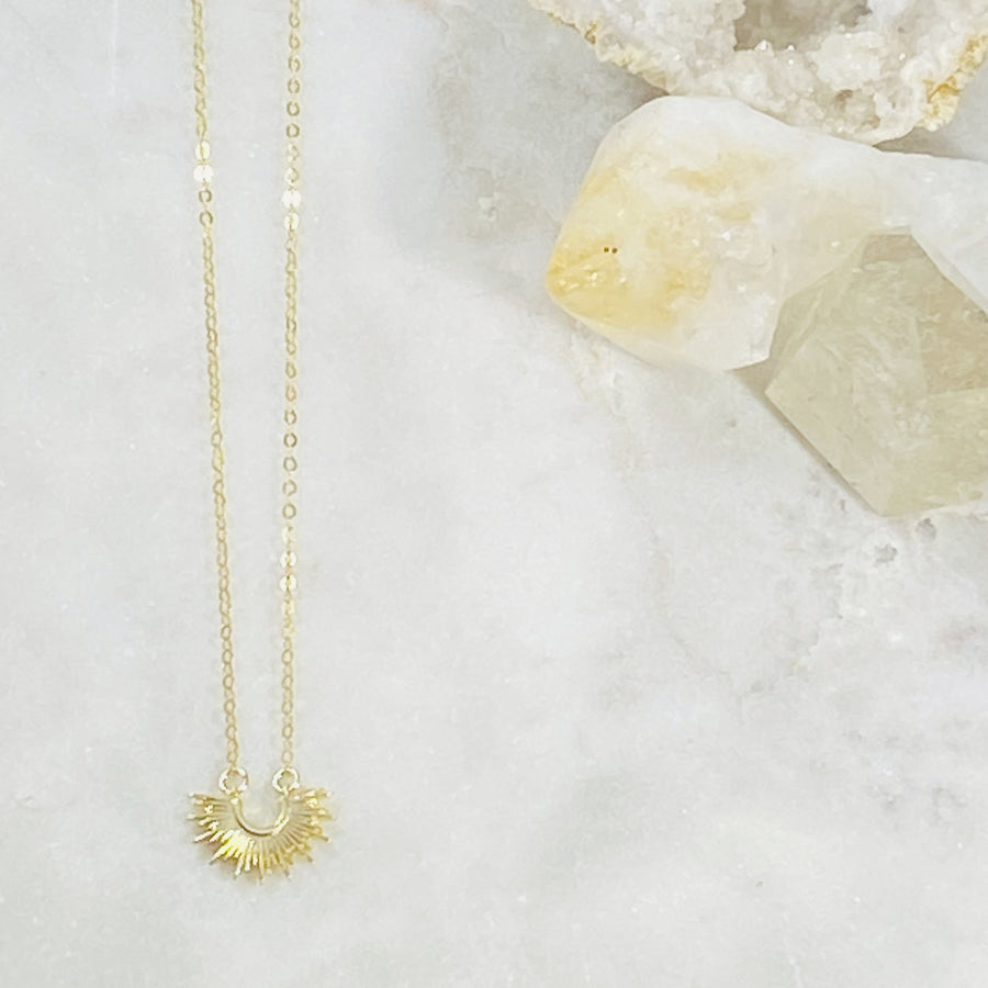 Handmade gold sol necklace symbolizing the sun